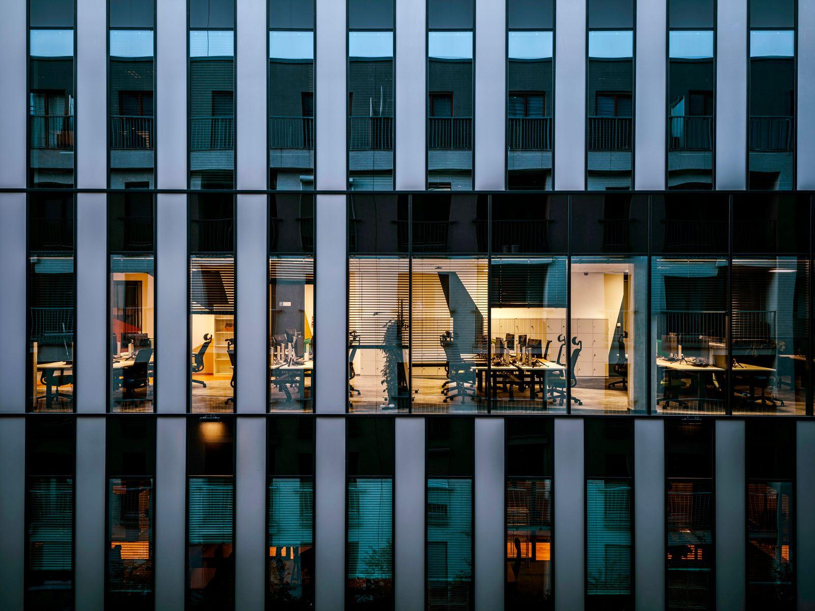 Illuminated office floor inside Junction Business Park at dusk