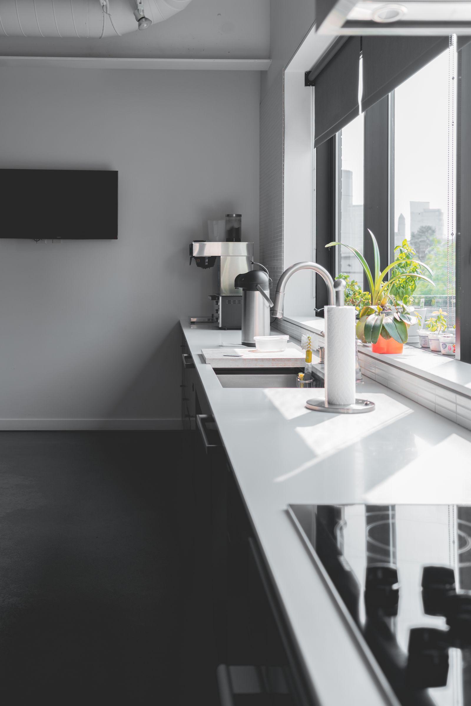 Kitchen with marble countertop and pendant lighting in a Meridian Residences apartment