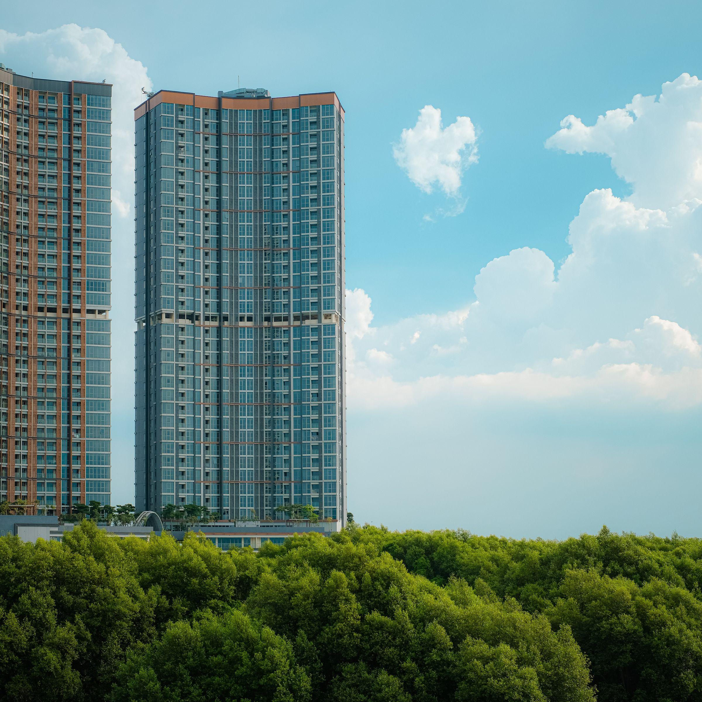Modern high-rise apartment towers set among green landscaping in Abuja